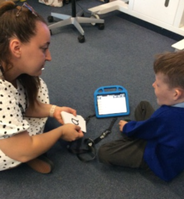 Aiden using his communication device